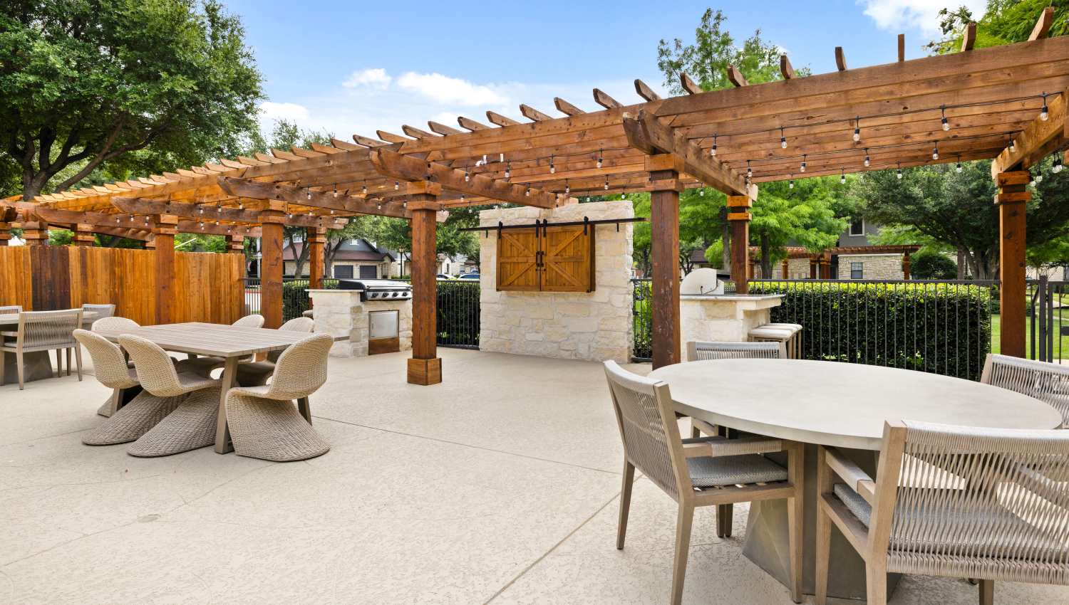 A patio with a pergola and tables at Olympus Town Center in Keller, Texas