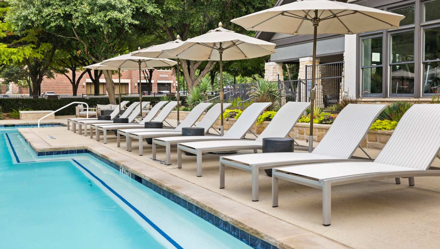 A swimming pool with lounge chairs Olympus Town Center in Keller, Texas