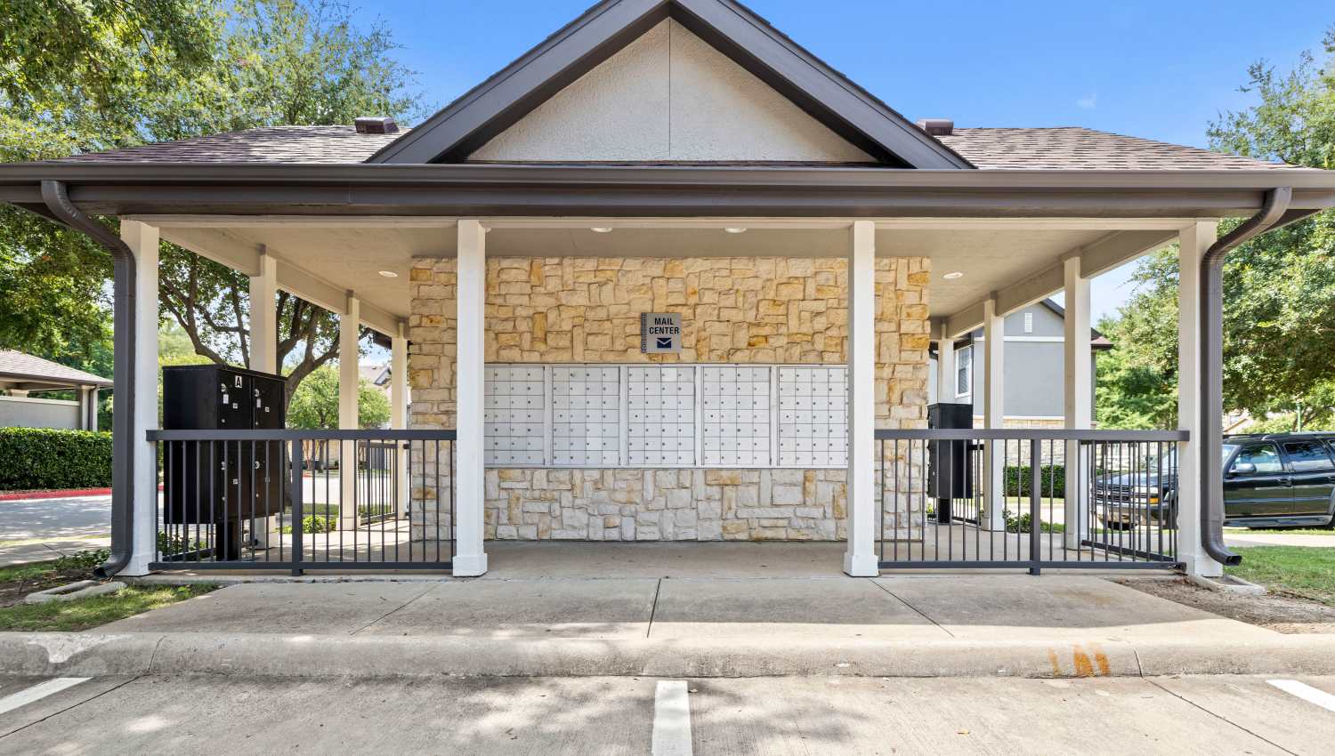 A building with a fence and a gate at Olympus Town Center in Keller, Texas
