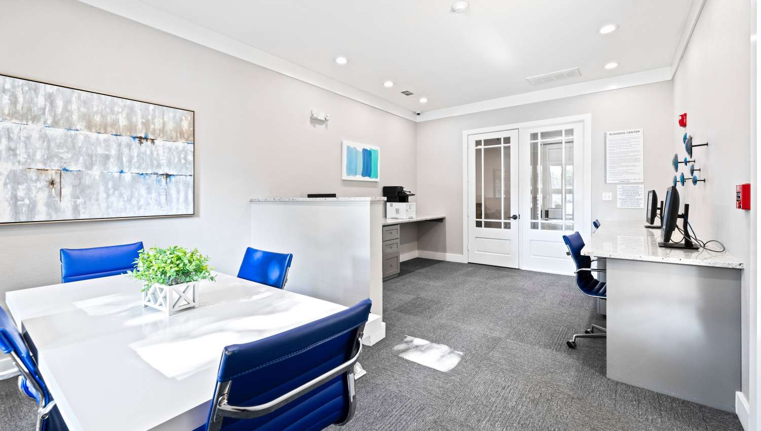 A room with a white table and blue chairs at Olympus Town Center in Keller, Texas