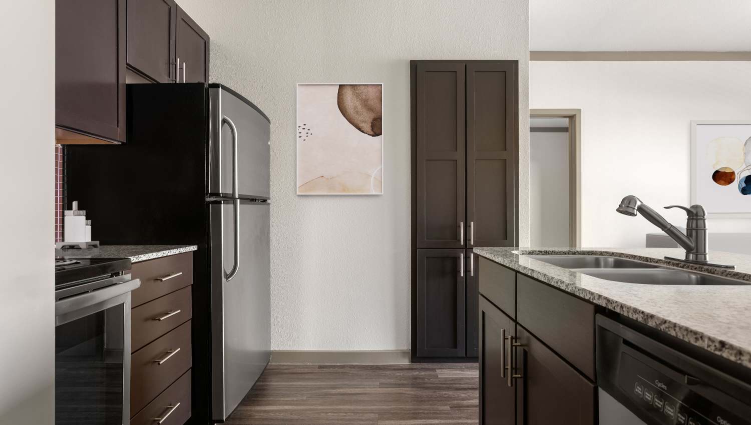 Model unit kitchen area with wooden cabinet at Tacara at Westover Hills in San Antonio, Texas