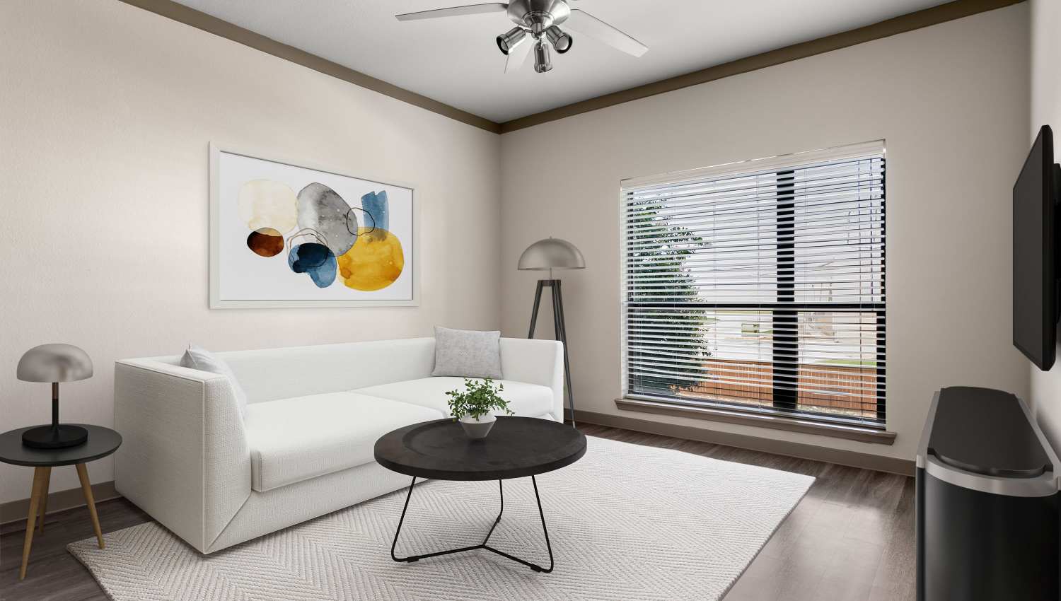 Model living room with ceiling fan at Tacara at Westover Hills in San Antonio, Texas
