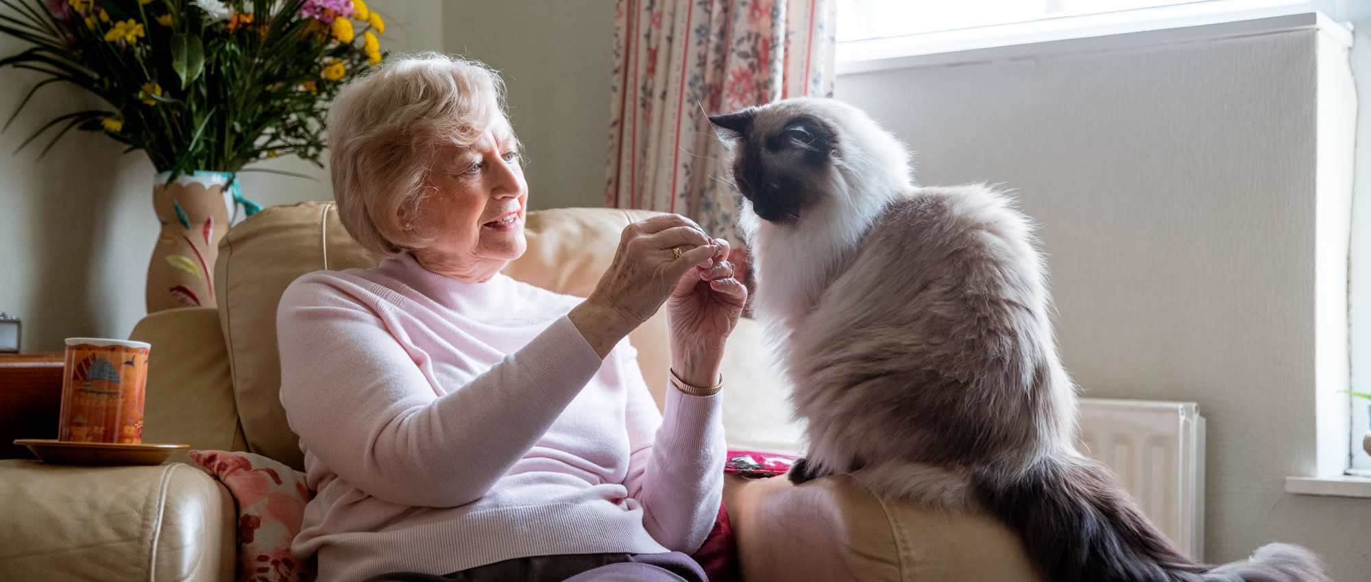 Resident with her cat at Grand Palms in Bradenton, Florida