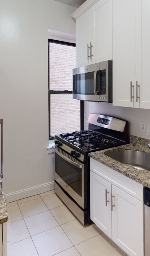 Stainless steal appliances in the kitchen at Eastgold NYC in New York, New York
