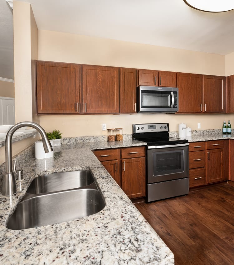 Model kitchen with stainless steel appliances at El Lago Apartments