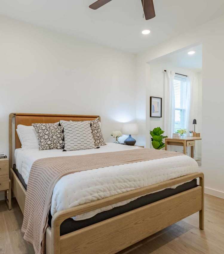 Cozy bedroom with wood-style flooring at The Ramsay in Springdale, Arkansas