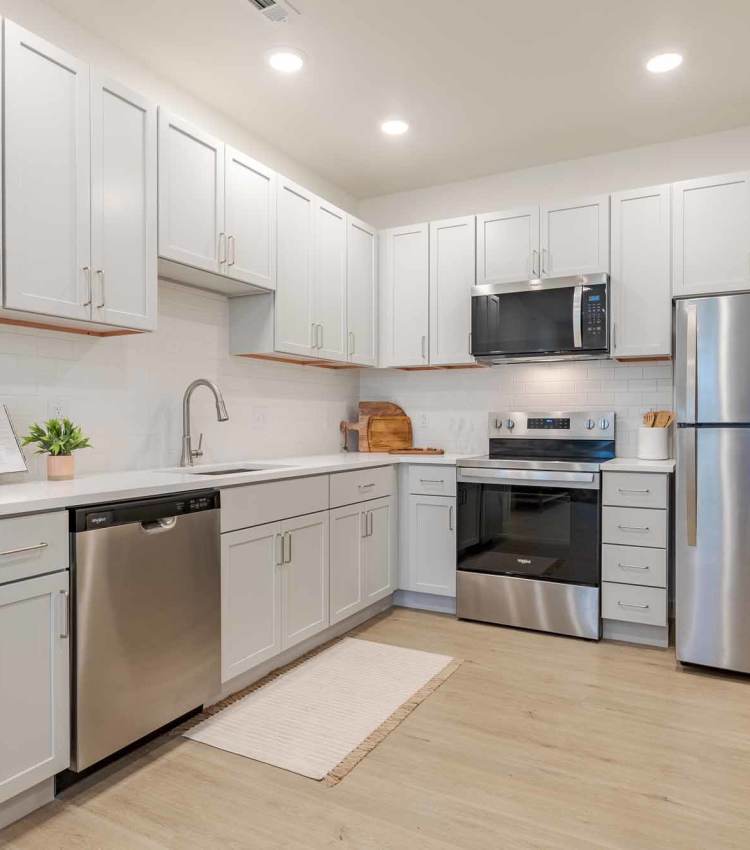 Open kitchen with white cabinetry at The Ramsay in Springdale, Arkansas