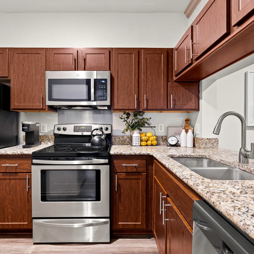 Stainless steel appliances and granite countertops in kitchen at Mira Vista at La Cantera