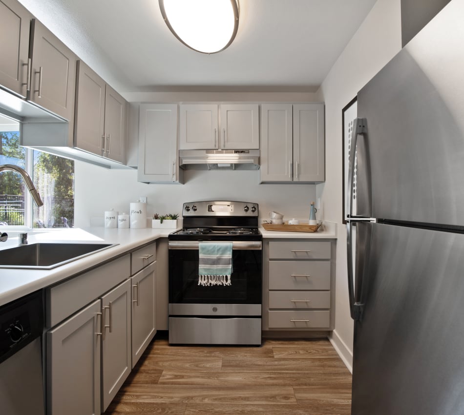 Modern kitchen with granite countertops and stainless-steel appliances in a model home at Sofi Lakeside in Everett, Washington