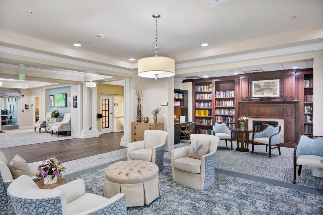 Community lounge with bookshelves at The Inn at Greenwood Village in Greenwood Village, Colorado