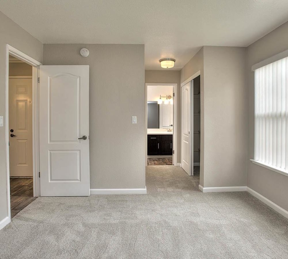 Spacious master bedroom with plush carpeting at Seventeen Mile Drive Village Apartment Homes in Pacific Grove, California