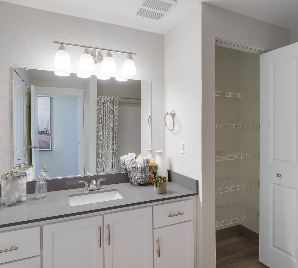White shaker panel cabinetry and a quartz countertop in a luxury model home's bathroom at Centro Apartment Homes in Hillsboro, Oregon