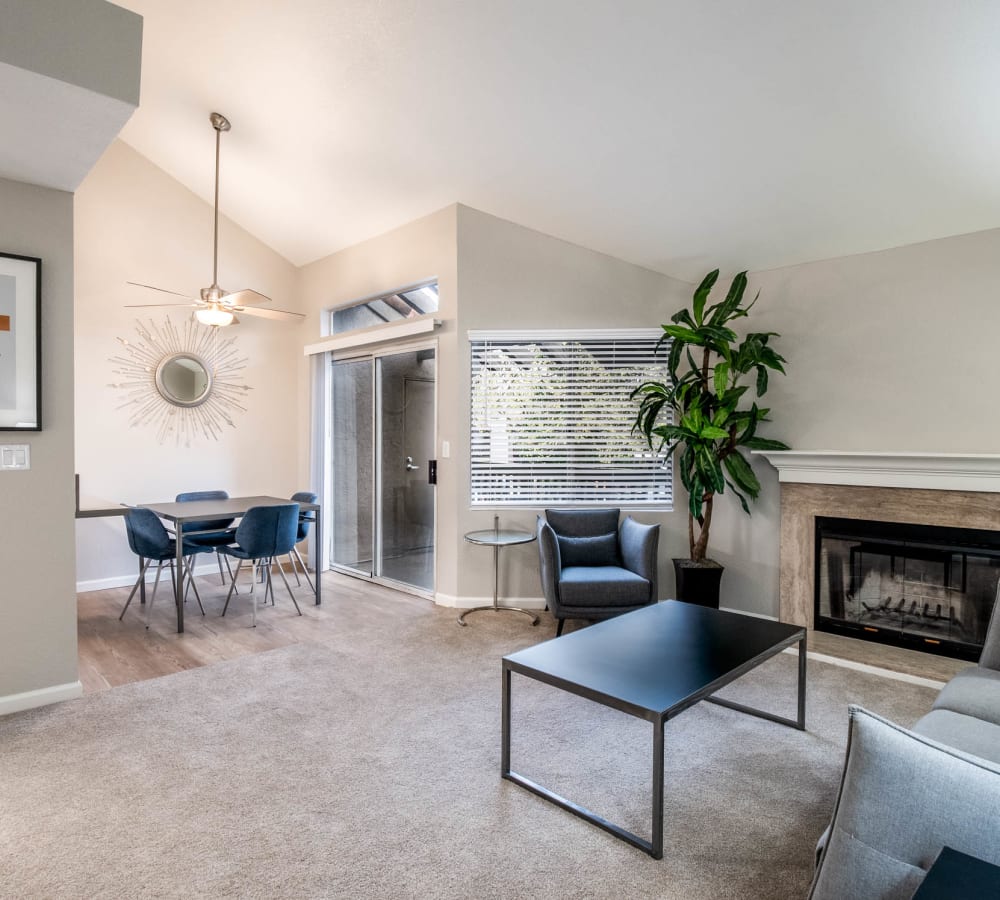 Spacious living room with plush carpeting and a fireplace at Shore Park at Riverlake in Sacramento, California