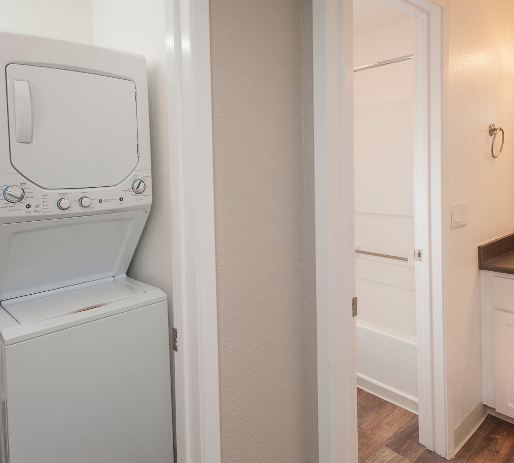 Bathroom with a stacked washer and dryer at Plum Tree Apartment Homes in Martinez, California