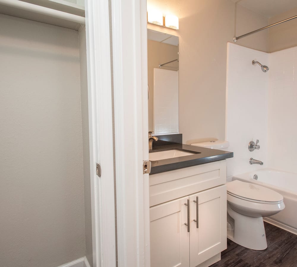 Bathroom with a vanity mirror at Regency Plaza Apartment Homes in Martinez, California