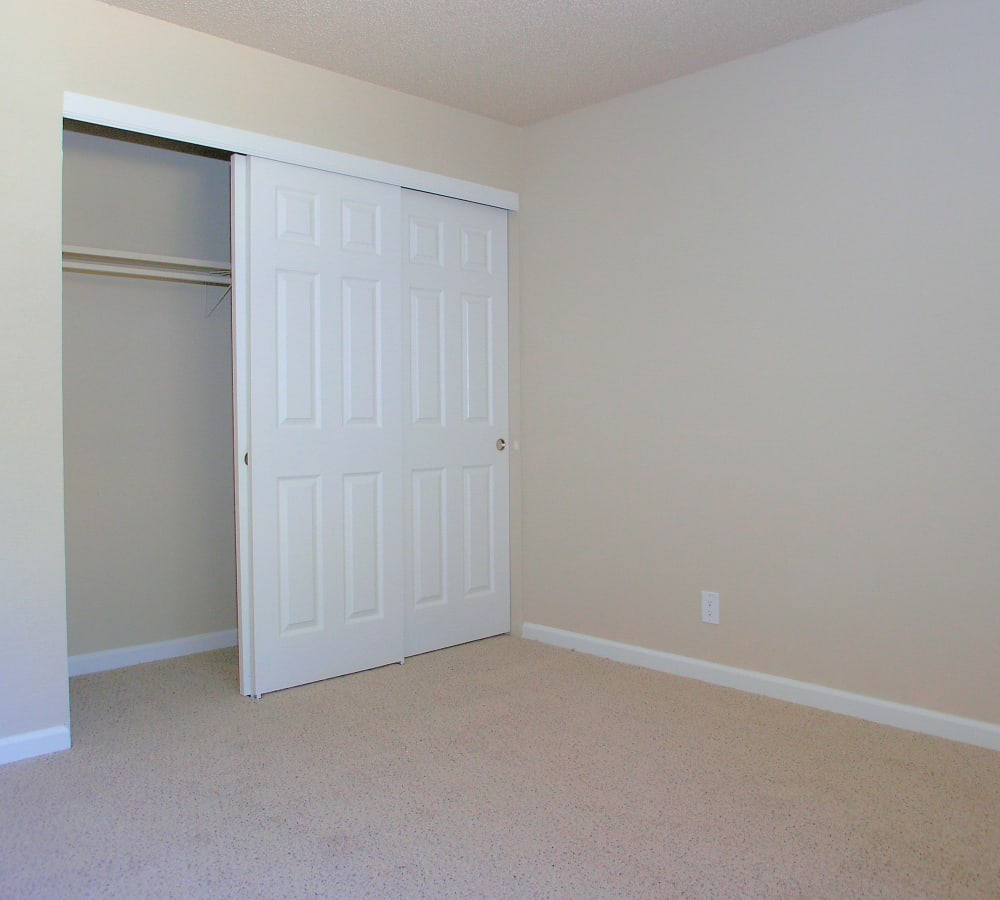 A roomy bedroom with a closet with modern white doors at Villa Palms Apartment Homes in Livermore, California
