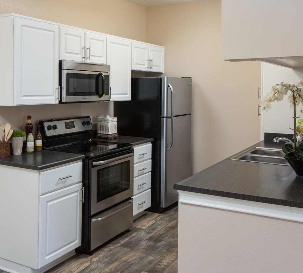 Luxury kitchen with stainless-steel appliances at Alicante Apartment Homes in Aliso Viejo, California