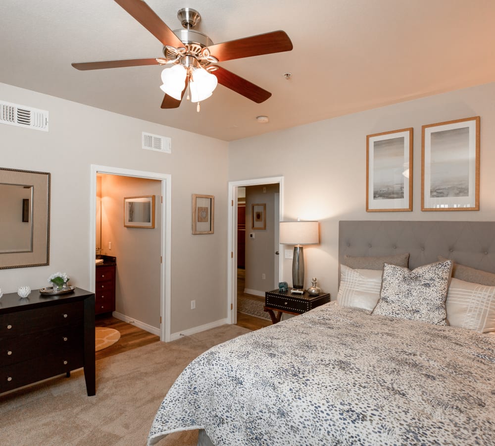 Main bedroom with plush carpeting and a ceiling fan at Wolf Ranch Condominium Rentals in Sacramento, California