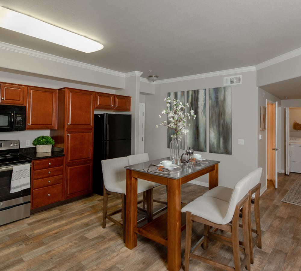 Dining room with wood-style flooring at Wolf Ranch Condominium Rentals in Sacramento, California