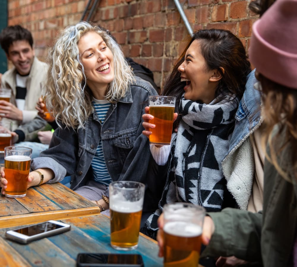 Friends enjoying beer together in Glen Burnie, Maryland near Glen Hollow Apartments