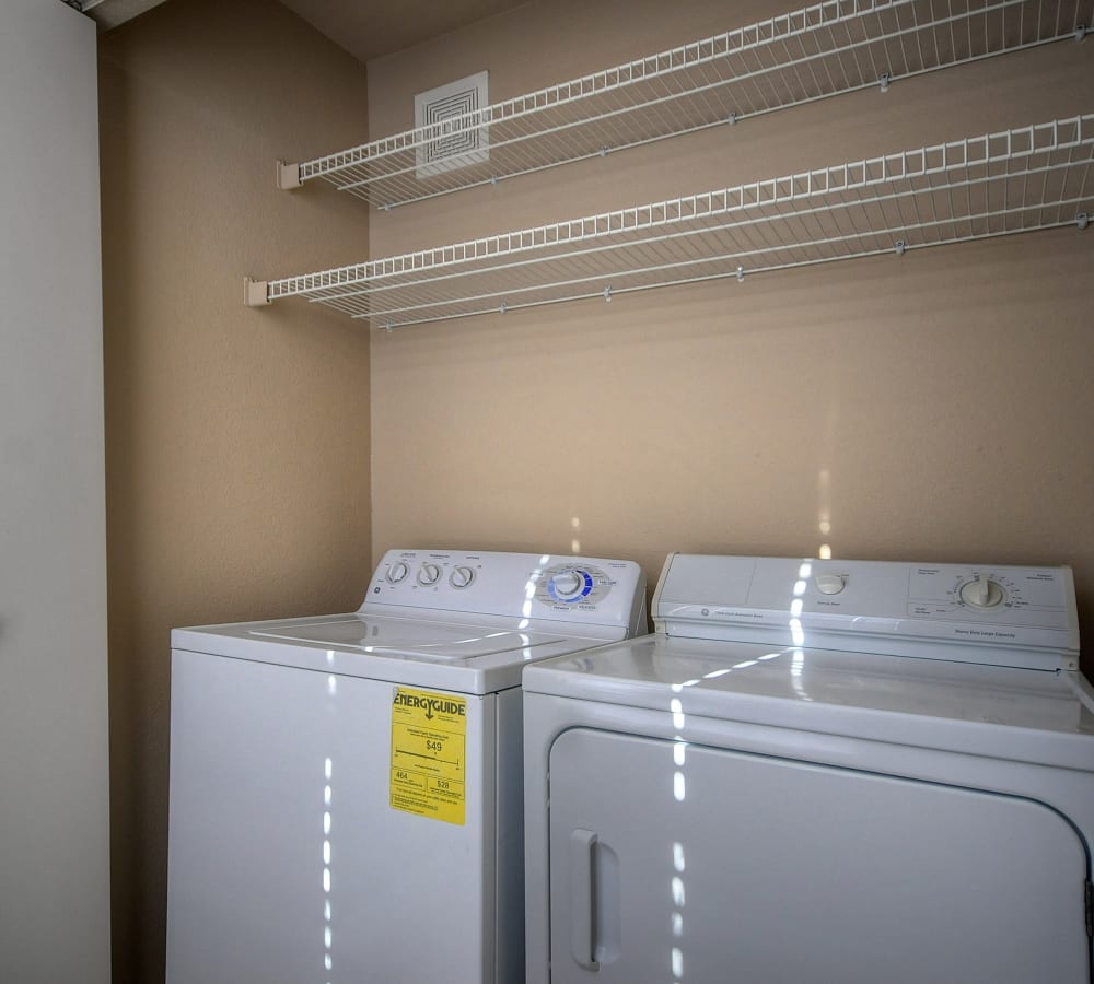 A washer and dryer with shelving at Larkspur Woods in Sacramento, California
