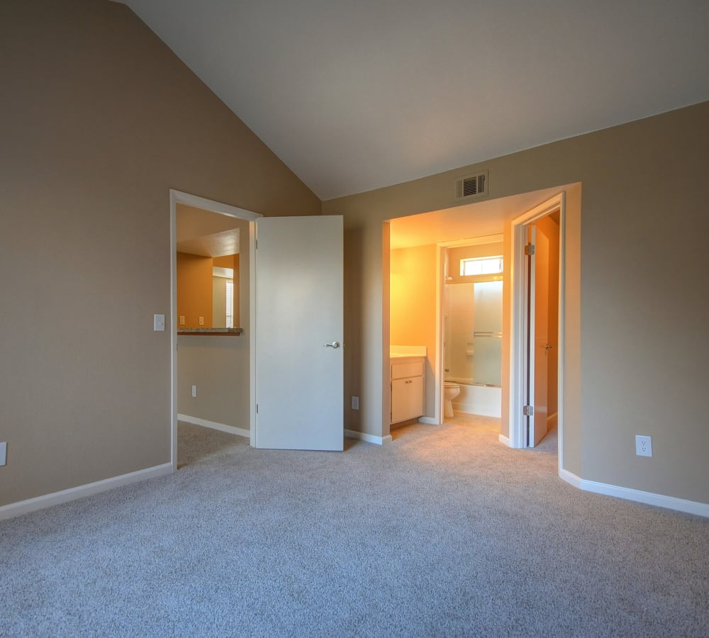 A main bedroom with plush carpeting at Larkspur Woods in Sacramento, California
