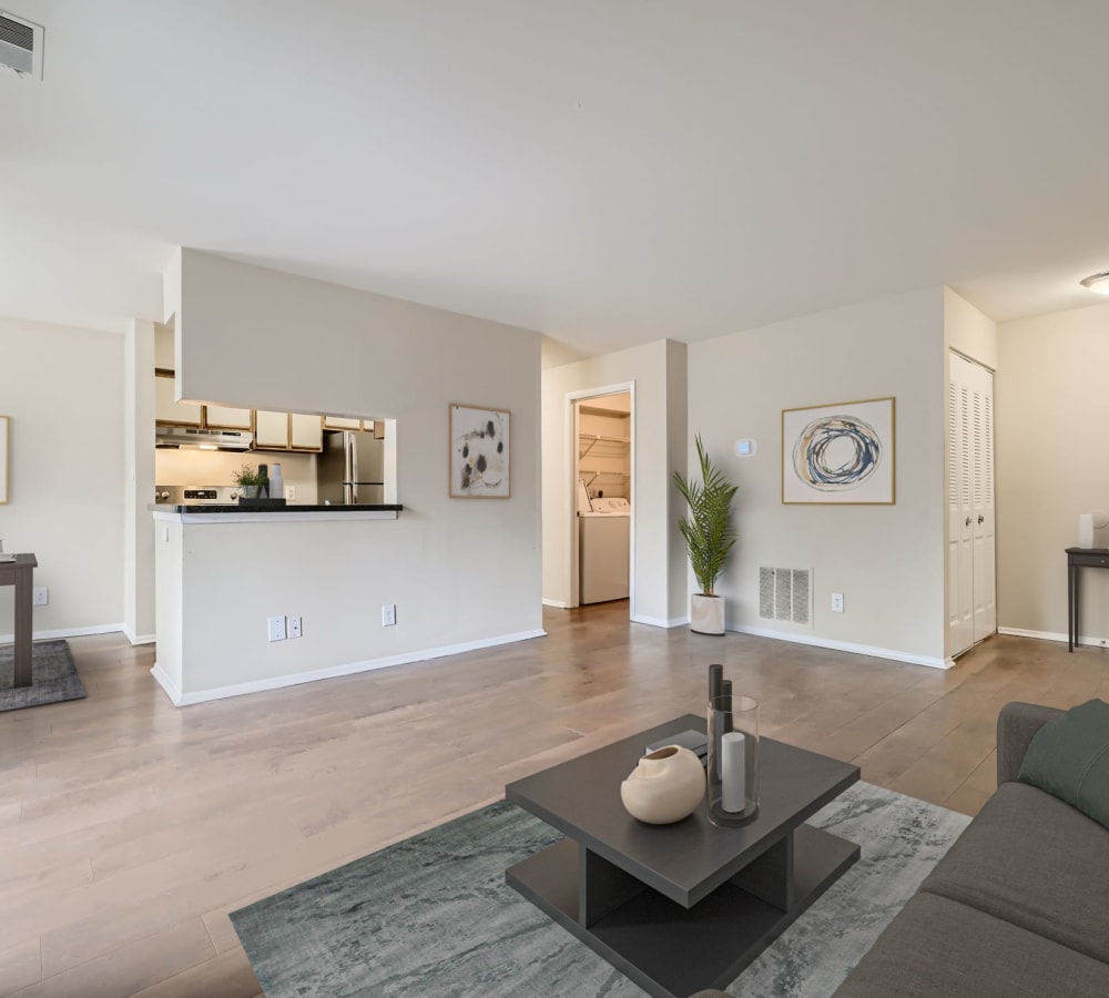 A furnished living room with wood flooring in an apartment at Hunt Club in Gaithersburg, Maryland