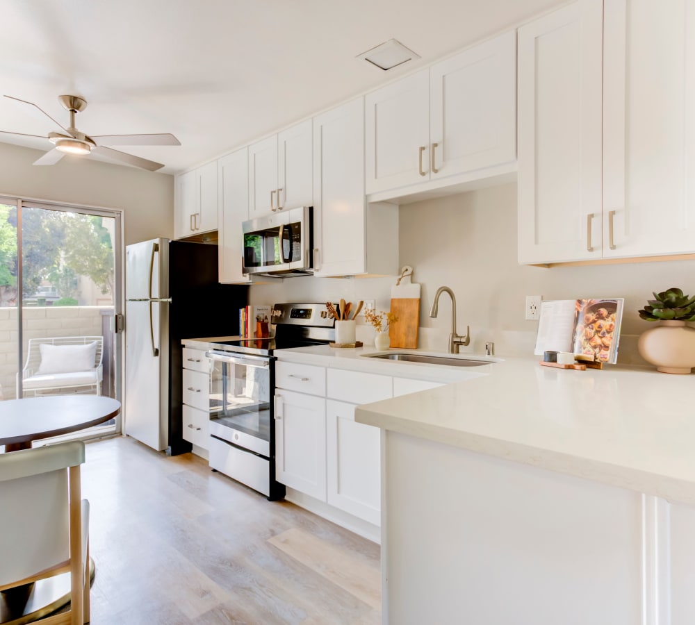 A fully equipped kitchen with dining area to prepare gourmet meals at Terra Camarillo in Camarillo, California