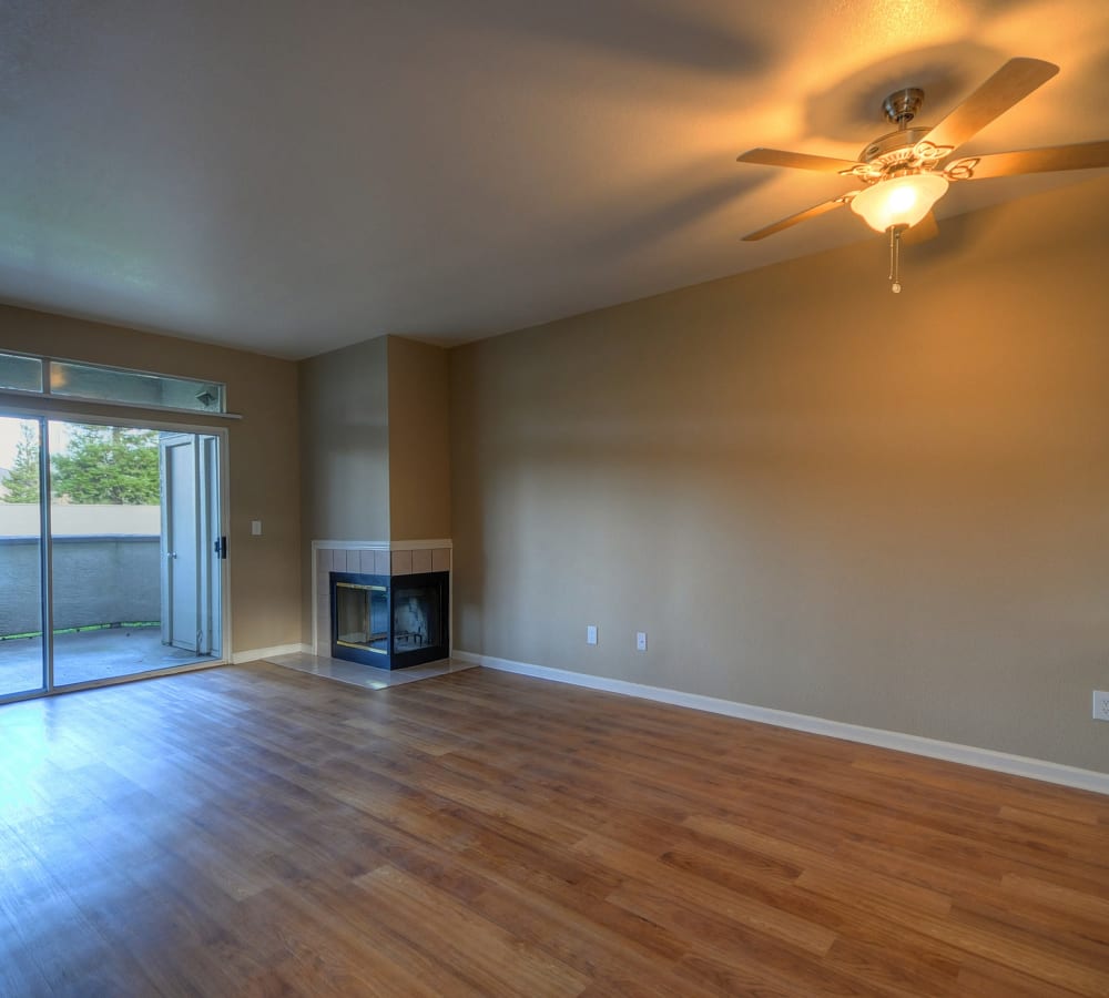 Living room with corner fireplace at Larkspur Woods in Sacramento, California