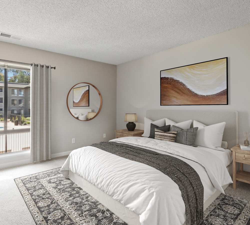 Bedroom with carpet and large window overlooking the pool at Muirwood Apartment Homes in Martinez, California