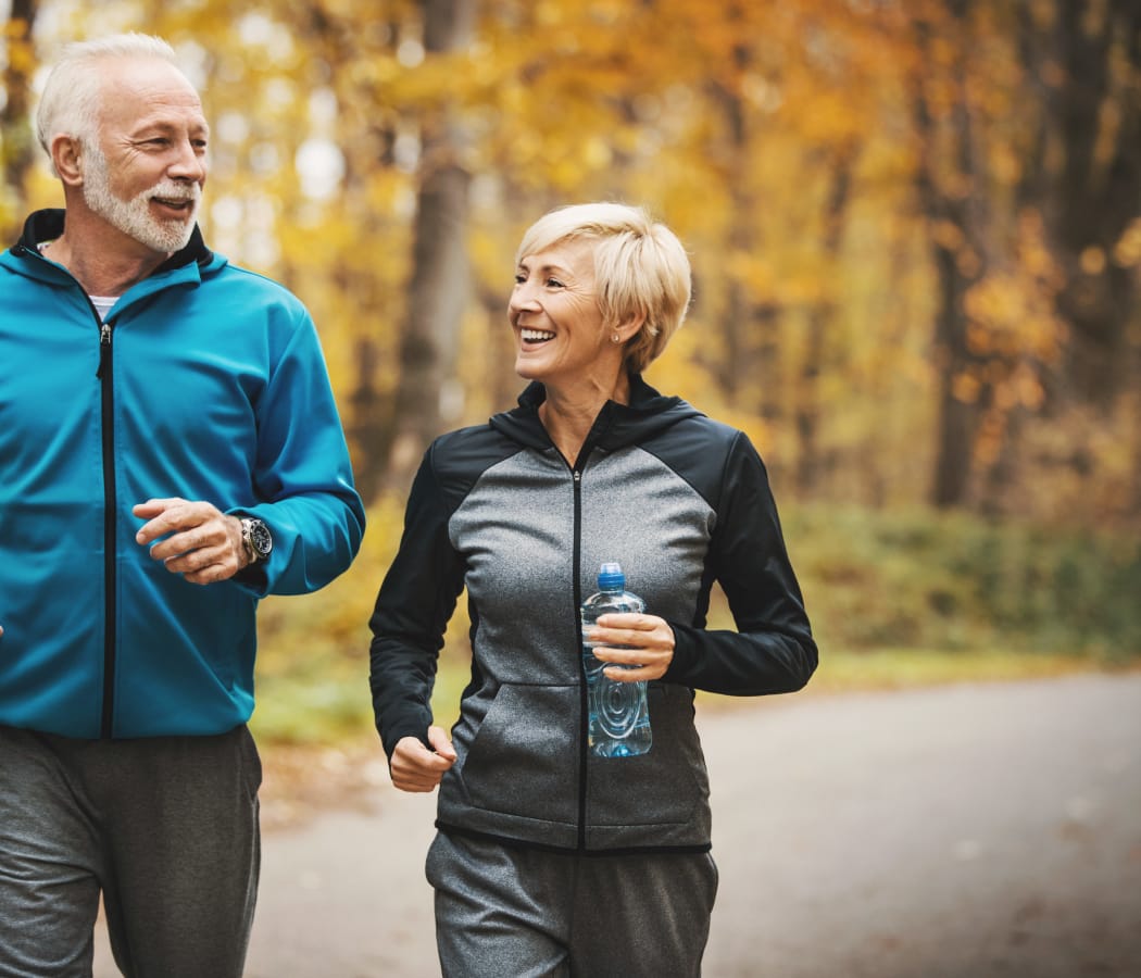 A couple running around our neighborhood at Orchard Hills Senior Apartments in Thornton, Colorado