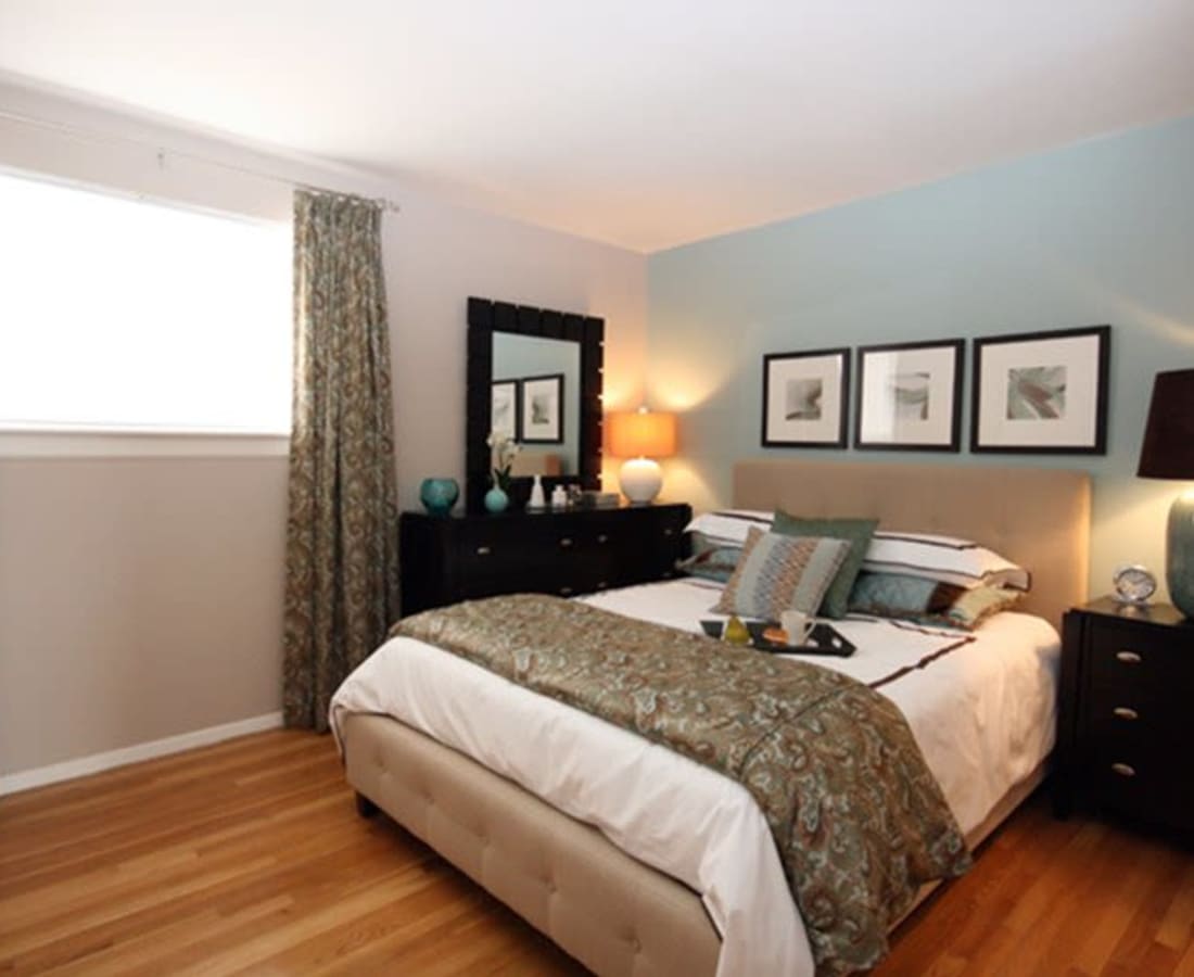 Large model bedroom with wood flooring at James River Pointe in Richmond, Virginia
