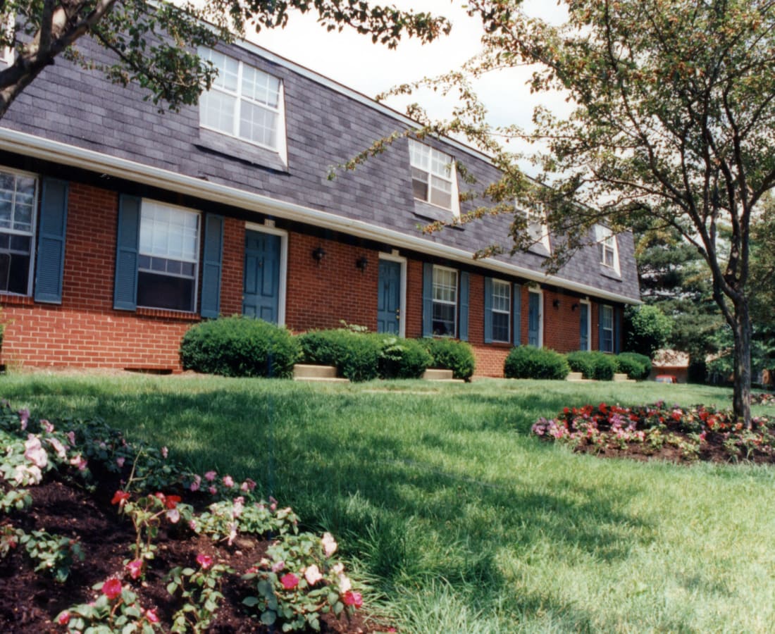 Brick apartment building exterior and manicured grounds at Pointe at Northern Woods in Columbus, Ohio