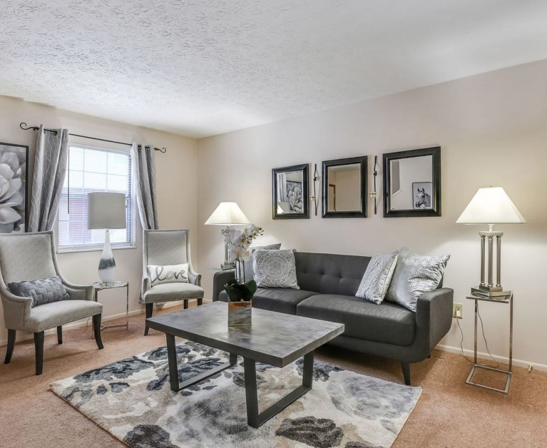 Comfortable living room with wall-to-wall carpeting in a model home at Pointe at Northern Woods in Columbus, Ohio