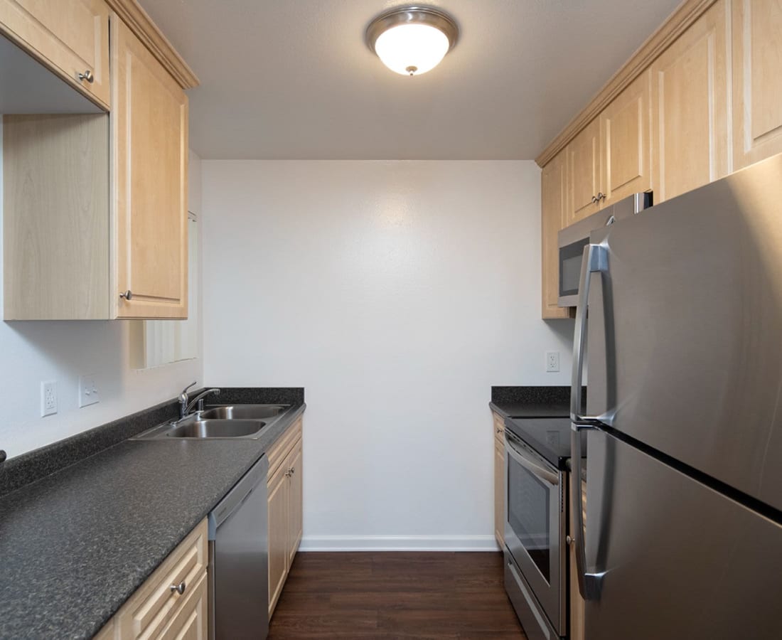 Kitchen with stainless steel appliances at Oro Vista Villas in San Diego, California