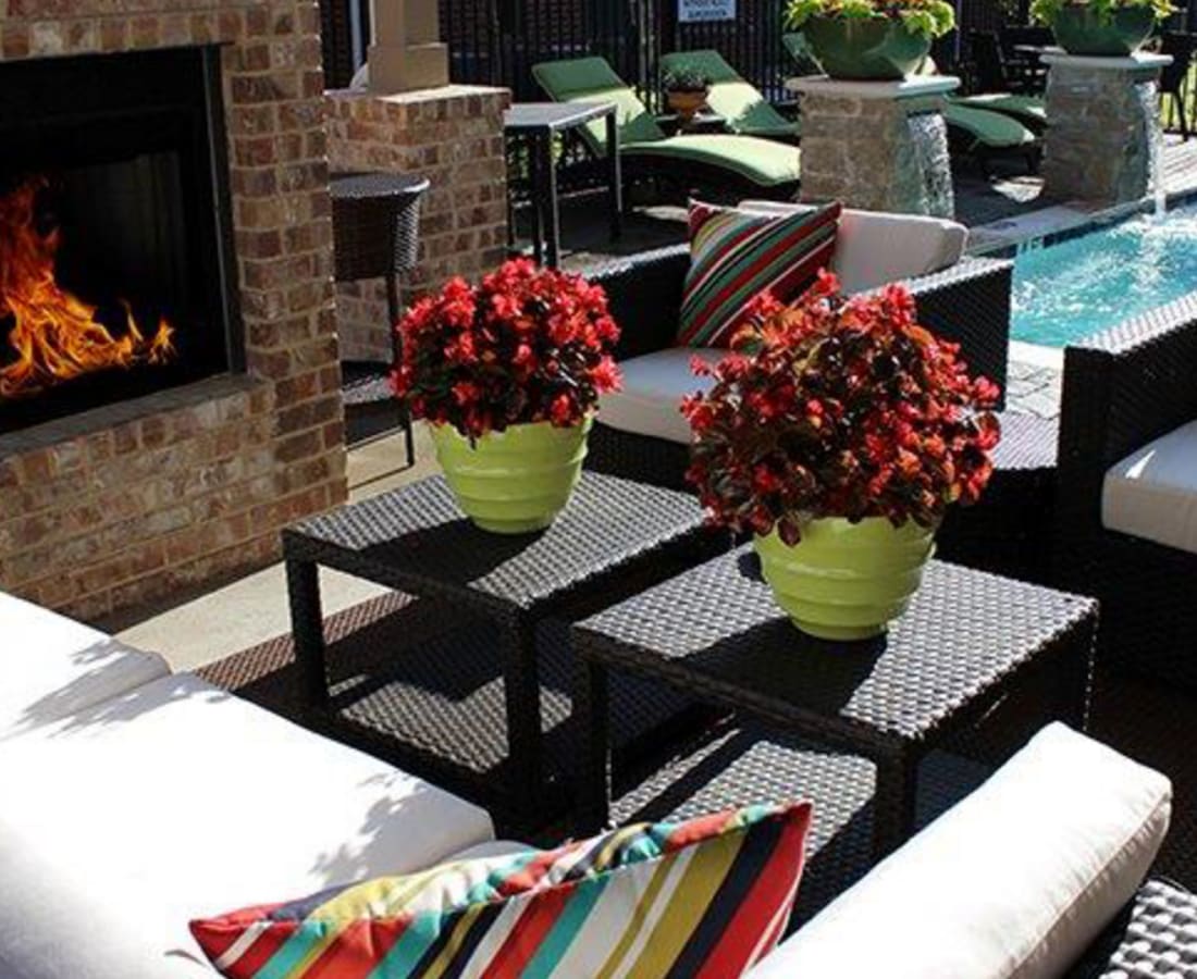 Poolside lounge with a fireplace at Parkside Towns in Richardson, Texas