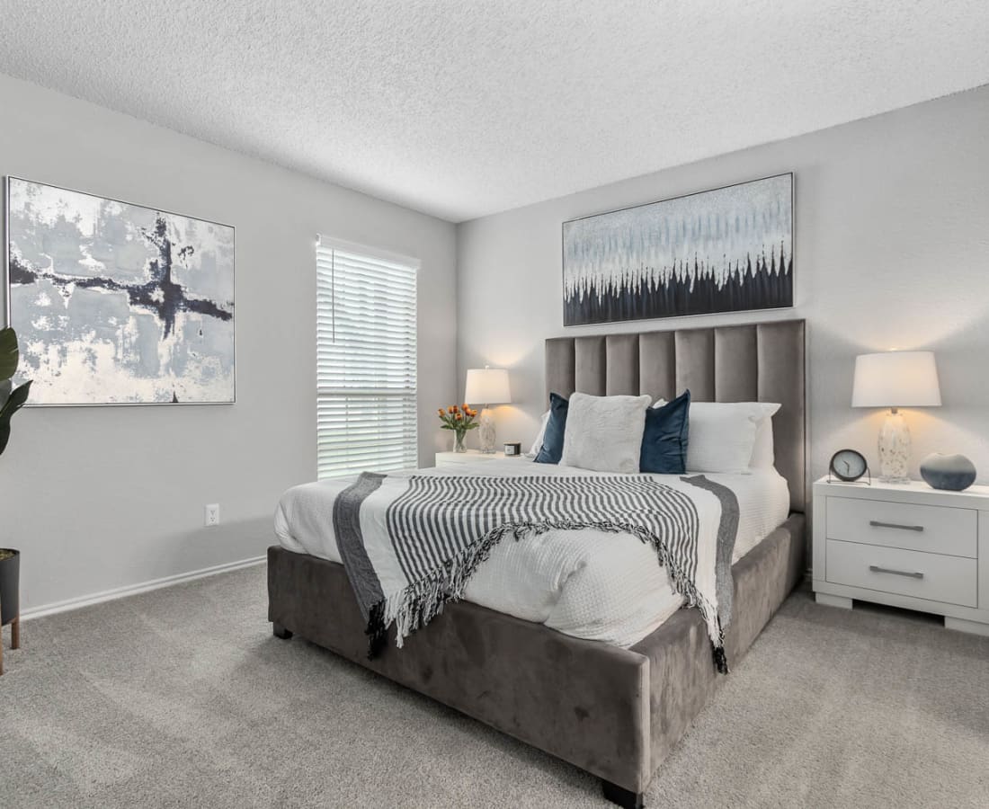 Model bedroom with large windows at Villas at Chase Oaks in Plano, Texas