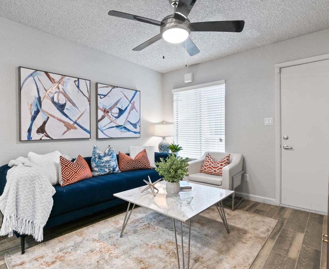 Model living room with a ceiling fan at Delano in Mesa, Arizona