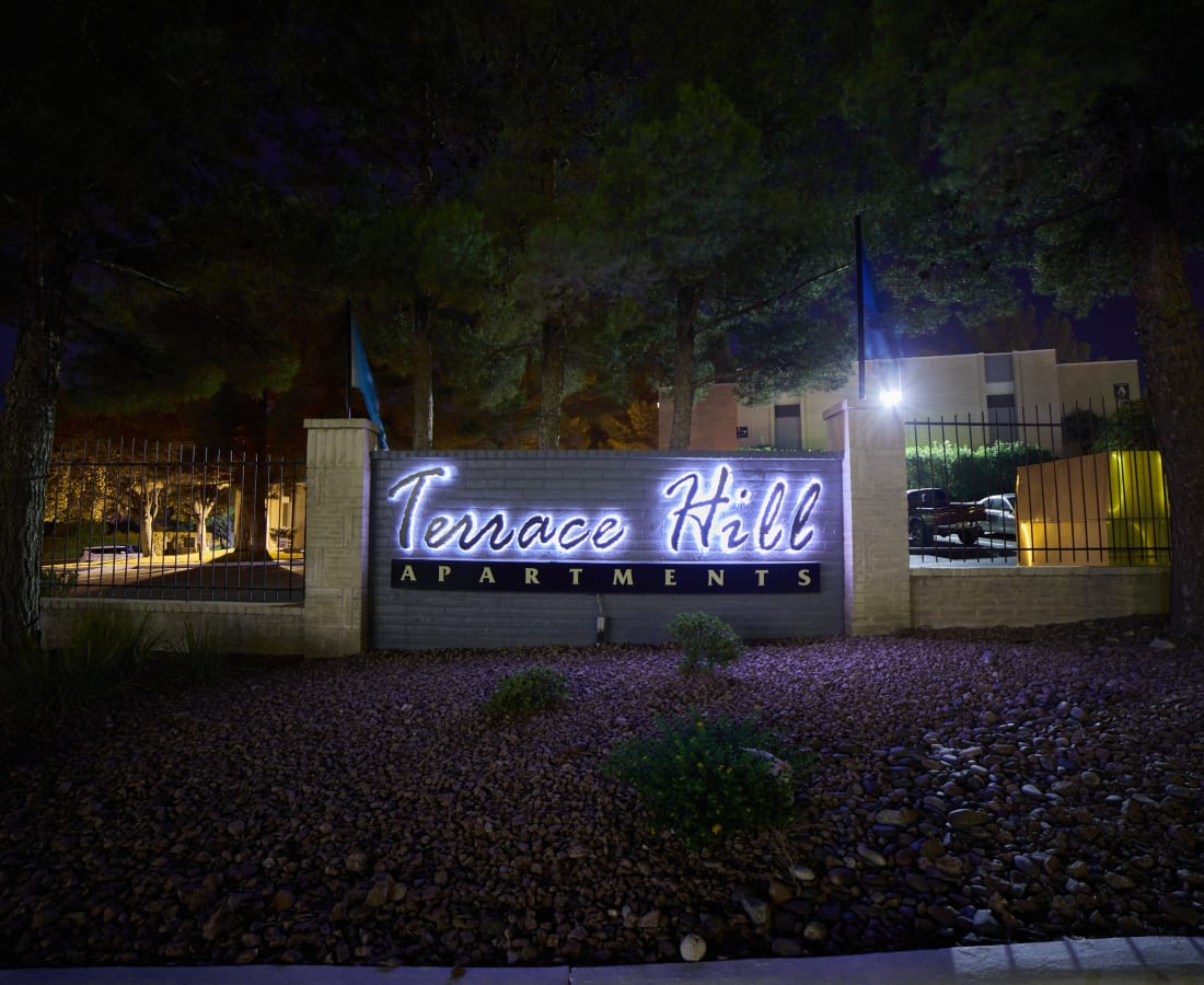 Exterior sign at night at Terrace Hill Apts in El Paso, Texas