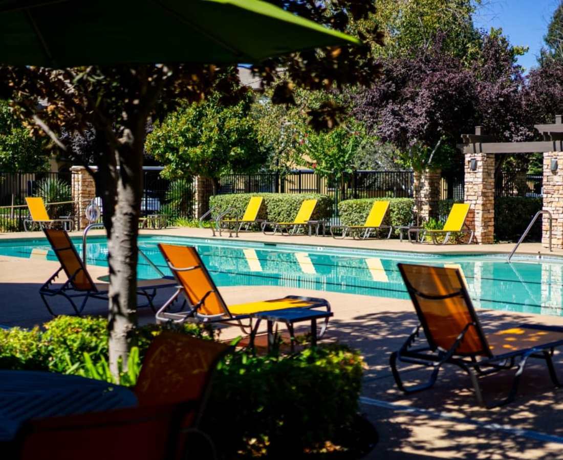 Sundeck and pool at Oak Brook Apartments in Rancho Cordova, California