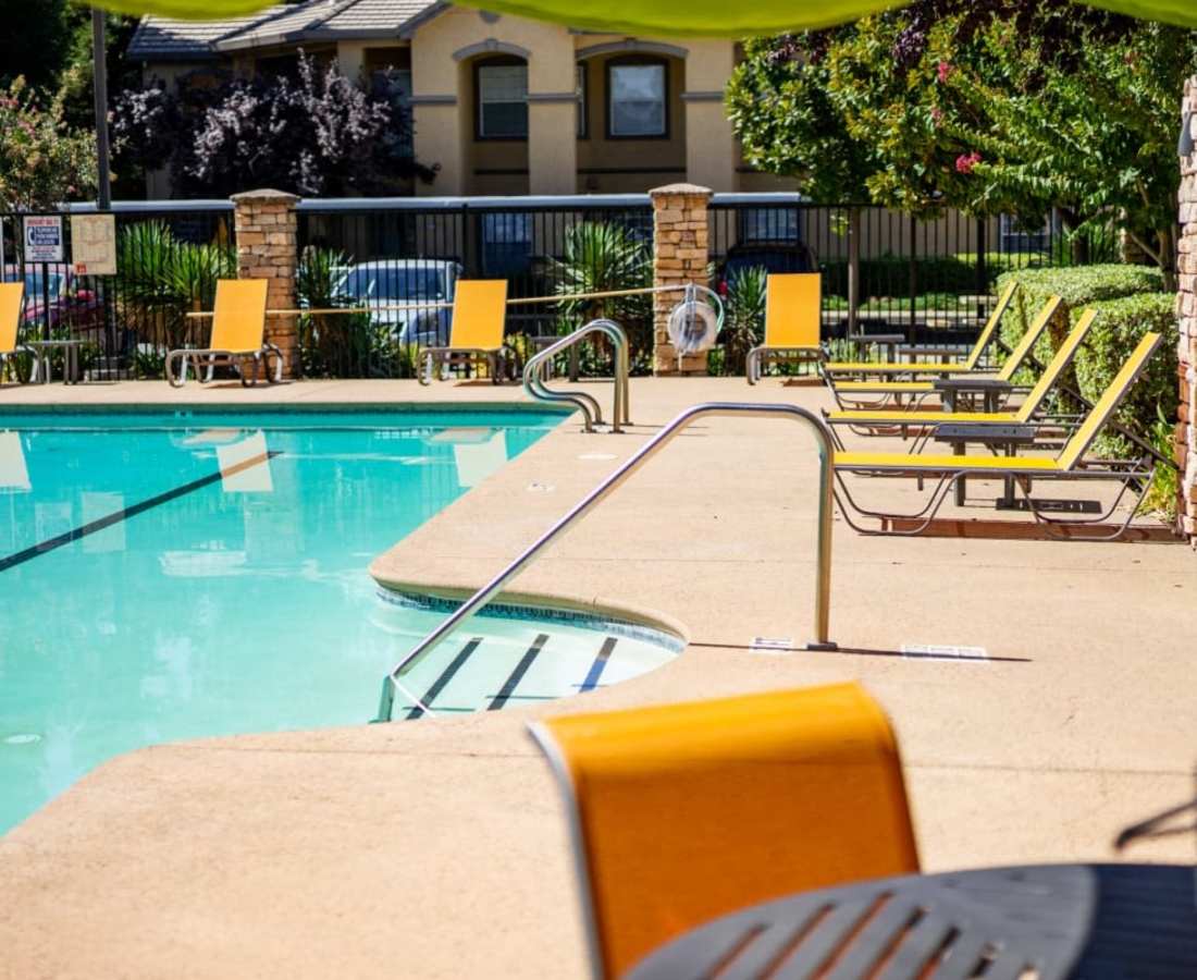 Pool and chairs at Oak Brook Apartments in Rancho Cordova, California