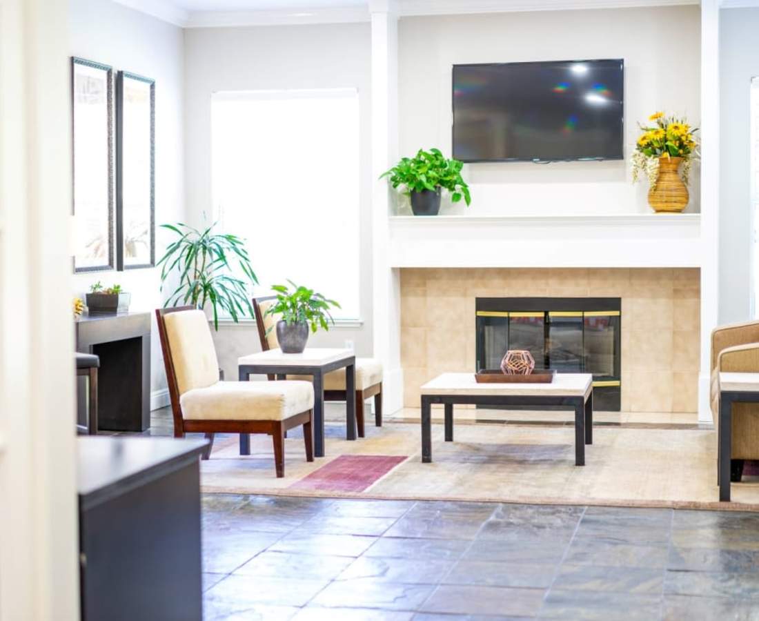 Resident lounge with TV at Oak Brook Apartments in Rancho Cordova, California