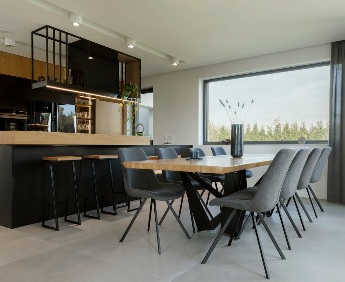 Bar seating and conference tables and chairs in the clubhouse lounge at The Fitz Apartments in Dallas, Texas