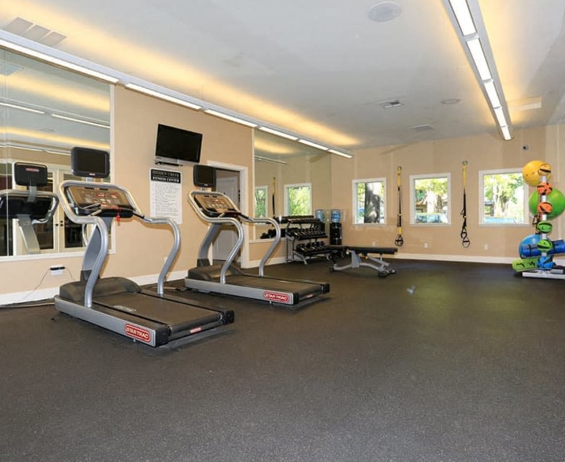 Modern gym fitness room with large windows and treadmills at Hidden Creek in Vacaville, California 