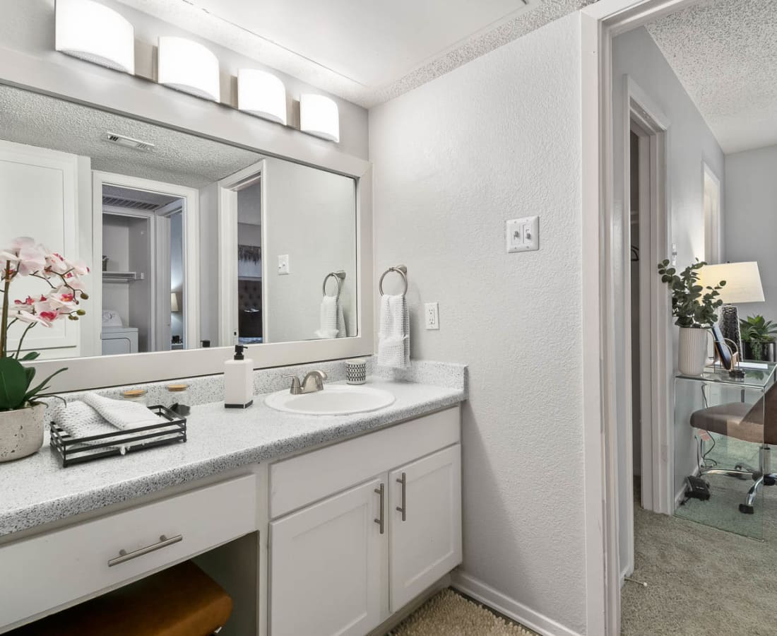 Model bathroom with a large vanity at The Carling on Frankford in Carrollton, Texas
