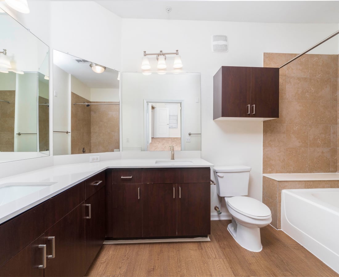Spacious bathroom with dark wood cabinets, and white countertops at Terraces at Town Center in Jacksonville, Florida
