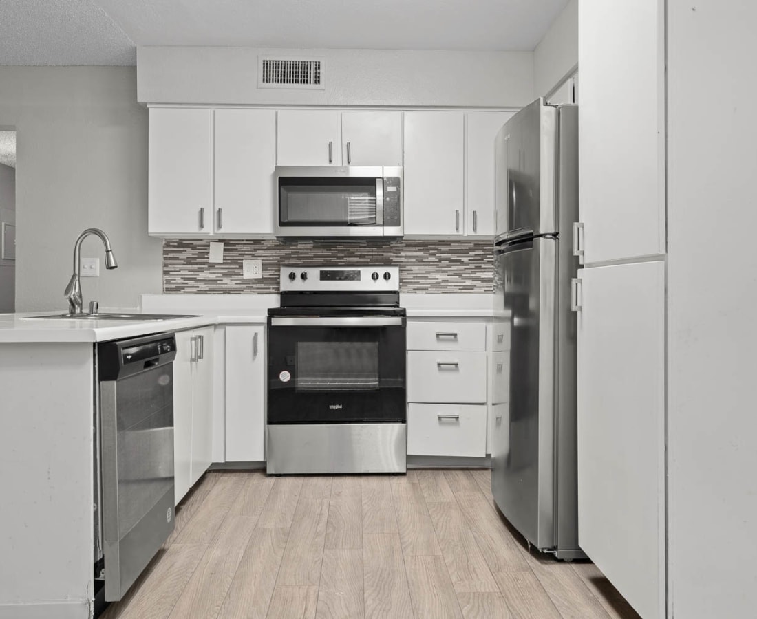 Open kitchen with stainless-steel appliances at Sedona Ridge in Las Vegas, Nevada