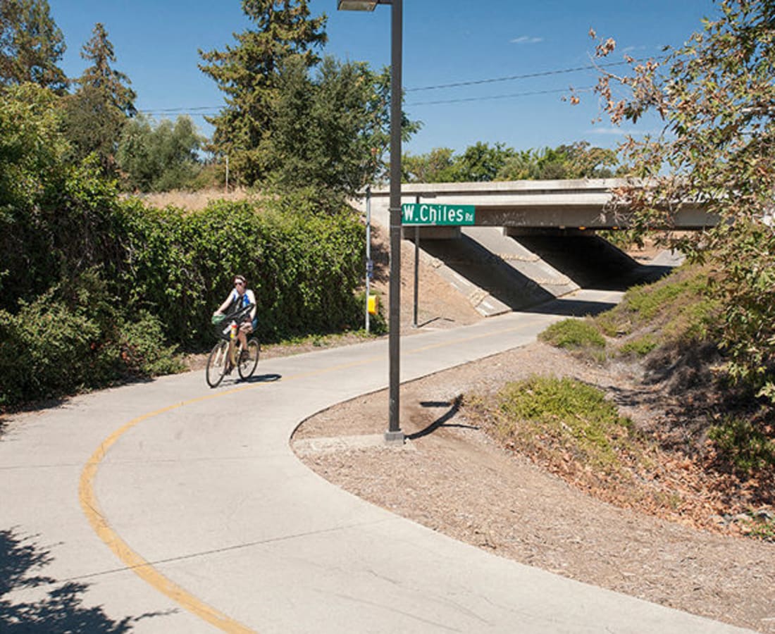 Woman cycling near DaVinci Apartments in Davis, California