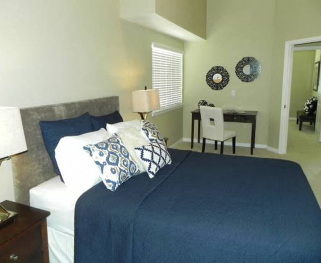 Comfortably furnished bedroom in a model apartment at DaVinci Apartments in Davis, California