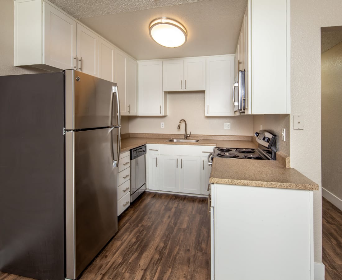 Model kitchen with wood-style flooring at The Edge in Modesto, California